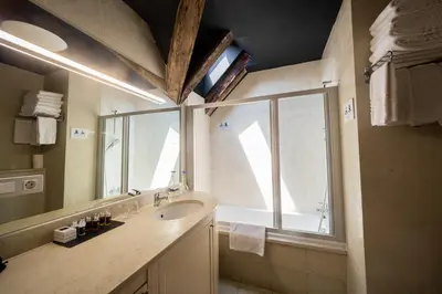a bathroom with a sink and a window at Miss Sophie's Charles Bridge in Prague