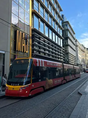 a red bus driving down a street next to a building at Hostel Downtown in Prague