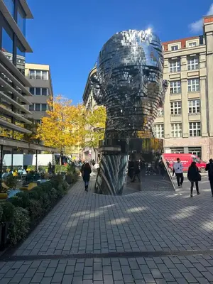 a metal sculpture on a sidewalk in a city at Hostel Downtown in Prague