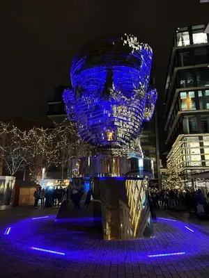 a blue glass sculpture is lit up at night at Hostel Downtown in Prague