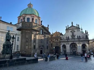 a group of people walking around a building at Hostel Downtown in Prague