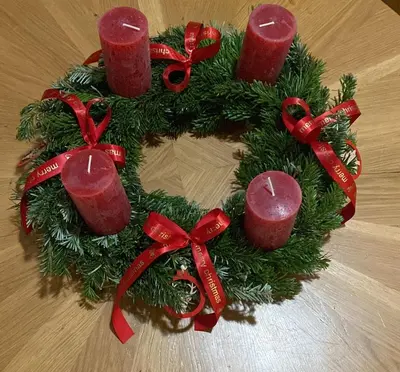 a christmas wreath with red candles on a table at Hostel Downtown in Prague