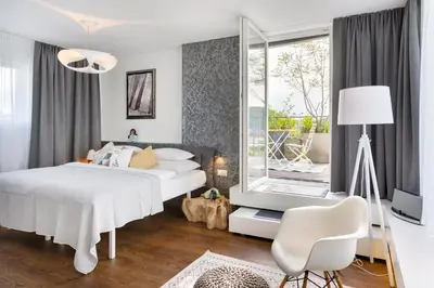 a bedroom with a white bed and a window at MOSAIC HOUSE Design Hotel in Prague