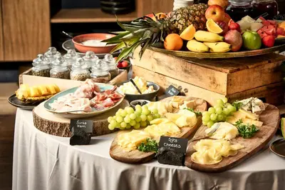 a table topped with plates of food and fruit at MOSAIC HOUSE Design Hotel in Prague