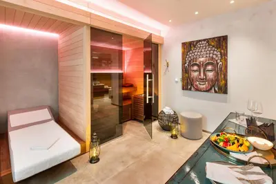 a living room with a large painting on the wall at MOSAIC HOUSE Design Hotel in Prague
