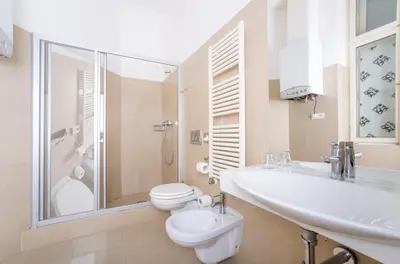a bathroom with a sink and a toilet and a shower at Deminka Palace in Prague