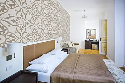 a bedroom with a large bed with a wall at Deminka Palace in Prague