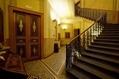 a hallway with a staircase in a building at Deminka Palace in Prague