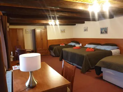 a room with two beds and a table with a lamp at Aaron in Prague