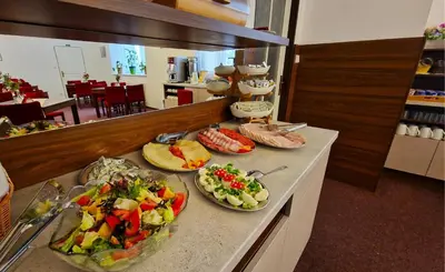 a buffet with several plates of food on a counter at Aaron in Prague