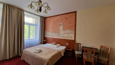 a hotel room with a bed and a map on the wall at Aaron in Prague