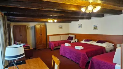 a hotel room with two beds and a couch at Aaron in Prague