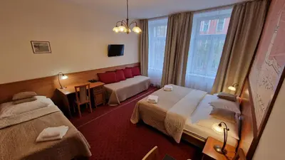 a hotel room with two beds and a window at Aaron in Prague