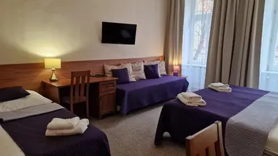 a hotel room with two beds and a television at Aaron in Prague