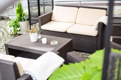 a patio with a couch and a table at Unitas Hotel in Prague