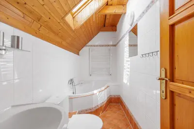 a bathroom with a toilet and a bath tub at Hotel BELLA in Prague