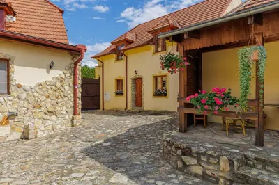 a courtyard of a house with a bench and flowers at Hotel BELLA in Prague