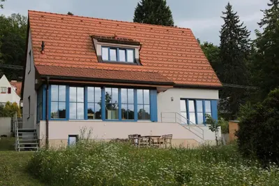a house with an orange roof and a table at Rekreační vilka Zlenice in Zlenice
