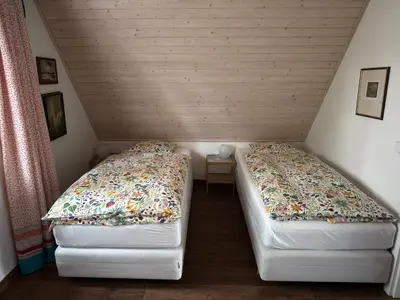 a bedroom with a bed with two lamps on it at Rekreační vilka Zlenice in Zlenice