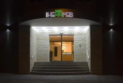 a neon sign above a staircase in a building at Hotel Herrmes in Prague