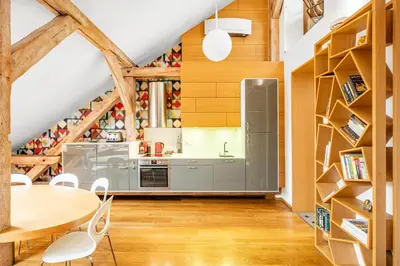 a kitchen with wooden ceilings and a table and chairs at Malostranská Residence in Prague