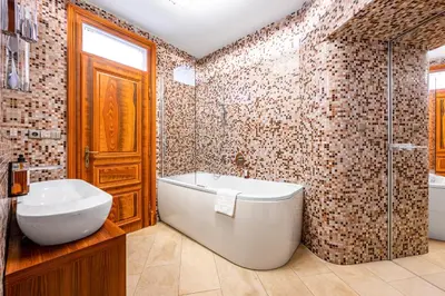 a bathroom with a tub and a toilet and a sink at Malostranská Residence in Prague