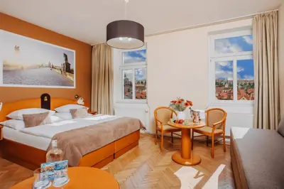 a hotel room with a bed and a table at Hotel Merkur - Czech Leading Hotels in Prague