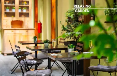 two tables in a room with chairs and wine glasses at Hotel Merkur - Czech Leading Hotels in Prague
