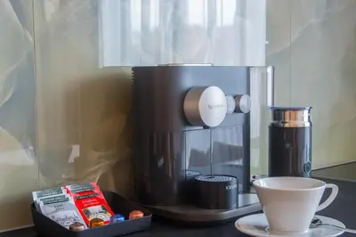 a coffee maker sitting on a counter next to a cup at Fully renovated stylish duplex in a convenient location in Prague