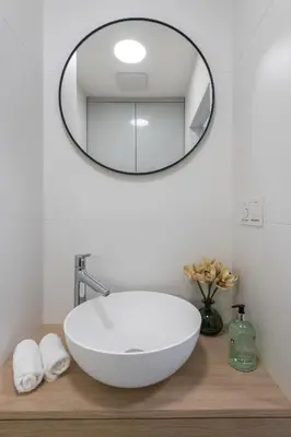 a bathroom with a white bowl sink and a mirror at Fully renovated stylish duplex in a convenient location in Prague