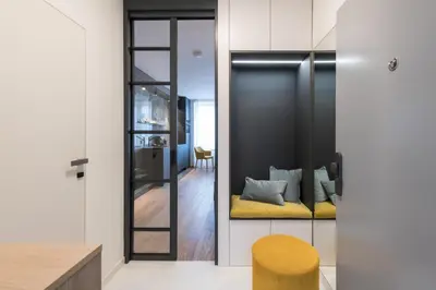 a living room with a yellow bench and a mirror at Fully renovated stylish duplex in a convenient location in Prague