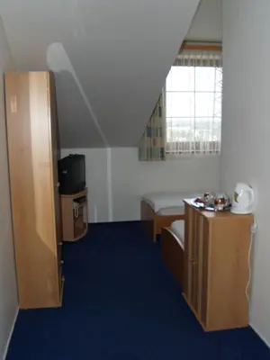 a small room with a bed and a small table at Motel U Krbu in Vestec