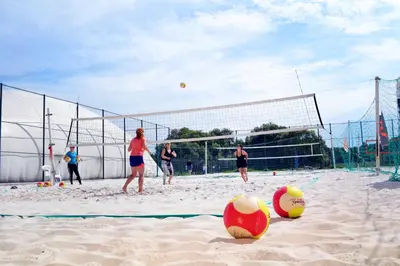 a group of people playing volley ball on a beach at Hotel S-centrum in Benešov