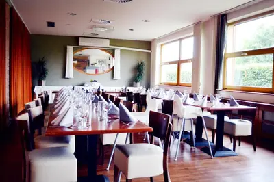 a dining room with a long table and chairs at Hotel S-centrum in Benešov