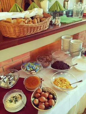 a table with many bowls of food on a counter at Hotel S-centrum in Benešov