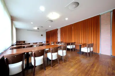 a dining room with a long table and chairs at Hotel S-centrum in Benešov