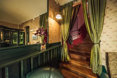 a room with a staircase and a window with curtains at Hotel Czechia in Prague