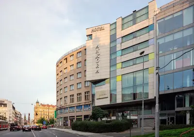 a building on the side of a street with cars at Hotel Ankora in Prague
