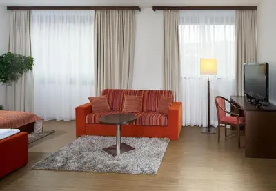 a living room with a couch and a table at Hotel Ankora in Prague
