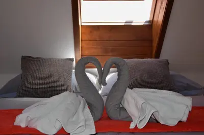 a bed with two swans made out of towels at Apartman Mala Strana -Piece and quiet in Prague