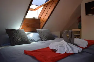 a bedroom with a bed with a towel on it at Apartman Mala Strana -Piece and quiet in Prague