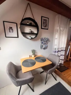 a dining room table with two chairs and a mirror at Apartman Mala Strana -Piece and quiet in Prague