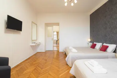 a hotel room with two beds and a flat screen tv at Vincanto Apartments Oldtown Prague1 in Prague