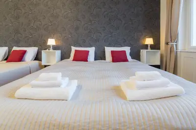 a large bed with two white towels on it at Vincanto Apartments Oldtown Prague1 in Prague