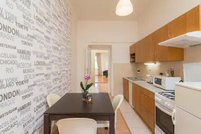 a kitchen with a table and chairs in a room at Vincanto Apartments Oldtown Prague1 in Prague
