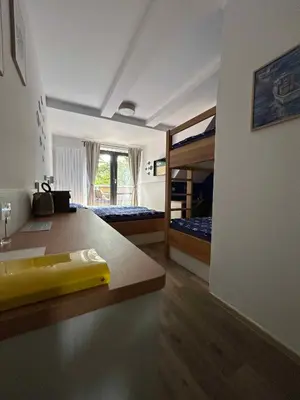 a room with a kitchen and a bunk bed at Penzion Labska Marina in Poděbrady