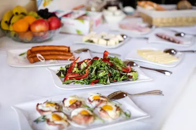 a white table with plates of food on it at Penzion Labska Marina in Poděbrady
