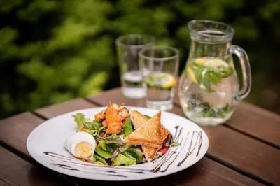 a plate of food on a wooden table at Penzion Labska Marina in Poděbrady