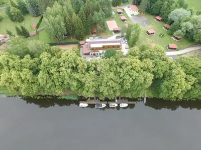 an aerial view of a house next to a lake at Penzion Labska Marina in Poděbrady
