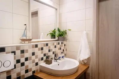 a bathroom with a sink and a mirror at Penzion Labska Marina in Poděbrady